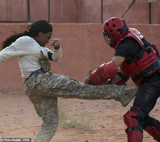 Hard kick: Reality star Kenya Moore, 50, also rose to challenge as she kicked hard and punched during the drill.