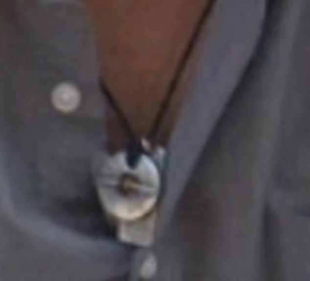 The necklace is made up of a leather cord with a silver pendant attached to the end (pictured).