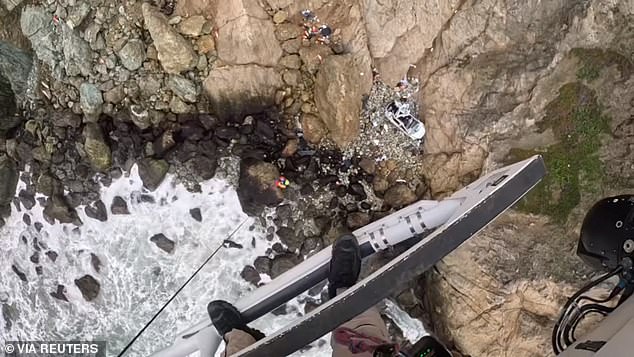 View from the rescue helicopter after a vehicle carrying two adults and two children plunged off a cliff in Devil's Slide, San Mateo County, California, on Monday.