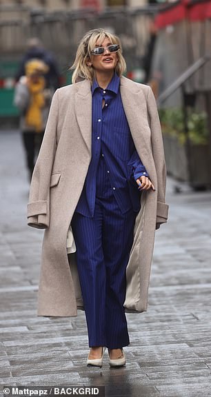 Rocking it: Ashley teamed the look with an oversized neutral coat, which she wore slung over her shoulders and styled with a pair of rectangular shades.