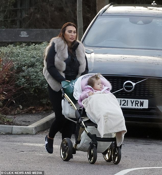 Family: Lauren shares her 15-month-old daughter Larose, whom she bundled up in a pink coat, with her ex-partner Charles Drur