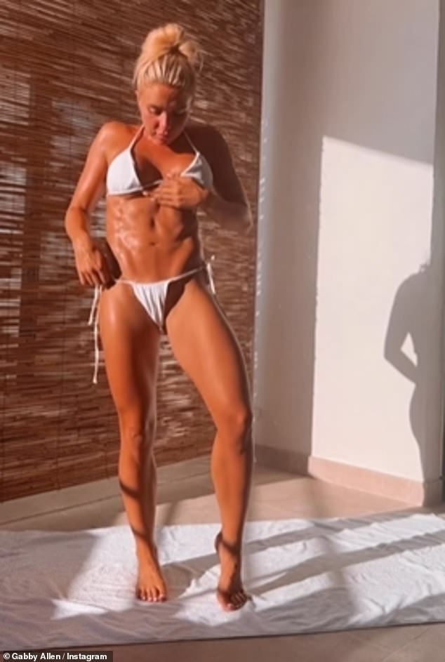 Ripped: The reality TV personality did not put on her makeup for the clip and tied her long blonde hair up in a chic bun as she posed on a towel