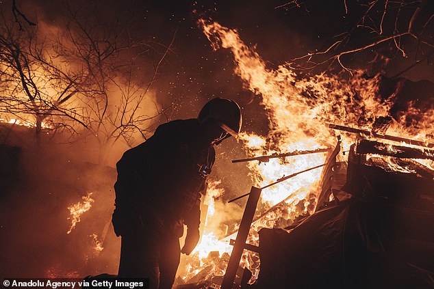 Emergency service workers extinguish a fire after shelling on the Bakhmut frontline in Ivanivske, Ukraine as Russia-Ukraine war continues