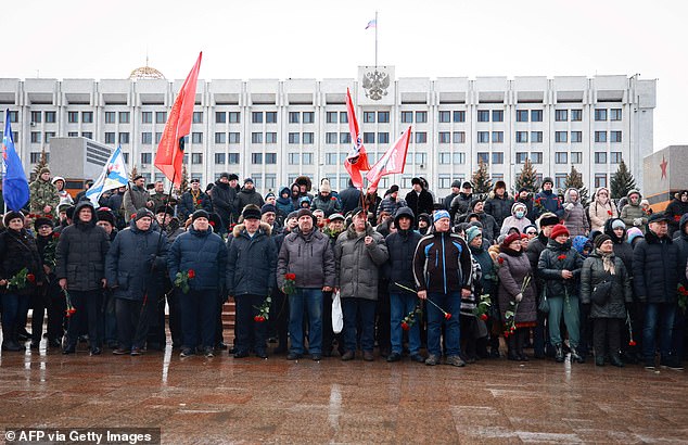 Mourners gather to lay flowers in memory of Russian soldiers that were killed in a Ukrainian strike