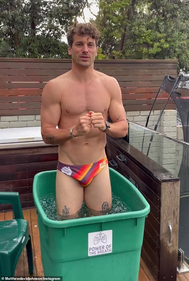 The newlywed, 35, stripped down to his boxers and showed off his tattooed body as he climbed into a plastic bin-style box filled with ice.