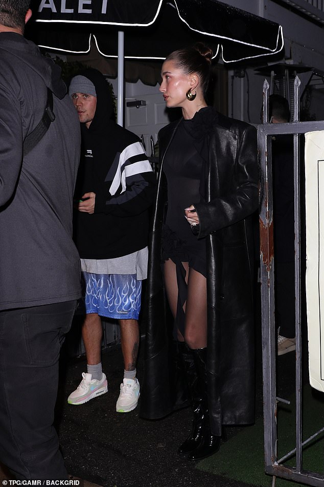 Casual: Her husband Justin was also in attendance for the night, wearing shorts and a hoodie