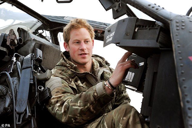 Prince Harry pictured doing pre-flight checks early in the morning in the cockpit of a helicopter.