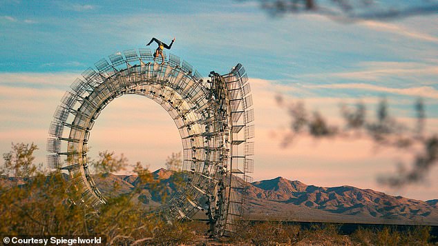 A Spiegelworld acrobat performs on a large sculpture previously used at a Burning Man festival