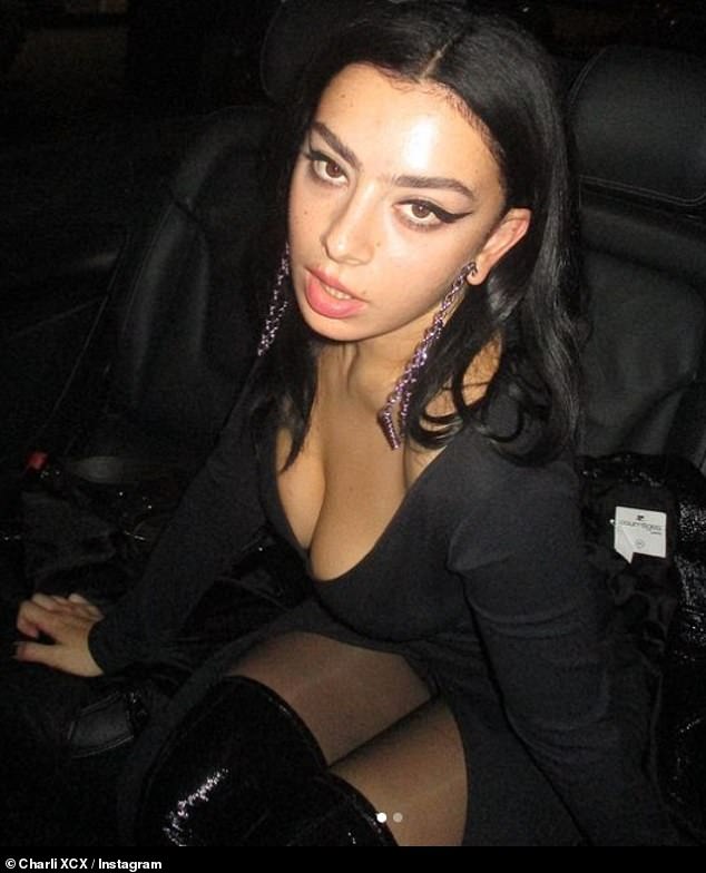 Glam: The surgery came after Charli called in the New Year.  The singer cut a glamorous figure as she snapped up from the back of a cab in a plunging black minidress.