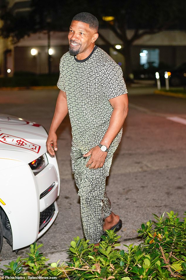 Smiling: Leo's Django Unchained co-star Jamie Foxx cut a casual figure in a graphic tee and matching pants