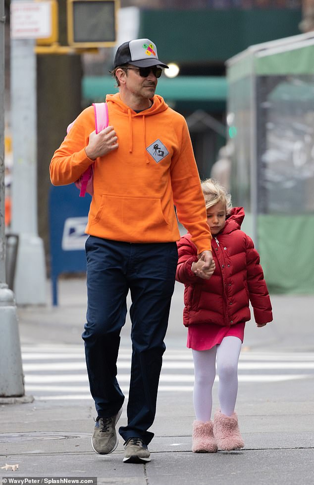 Nothing to miss him!  Despite hiding her famous face, she stood out in a bright orange sweatshirt paired with midnight blue pants and suede sneakers.