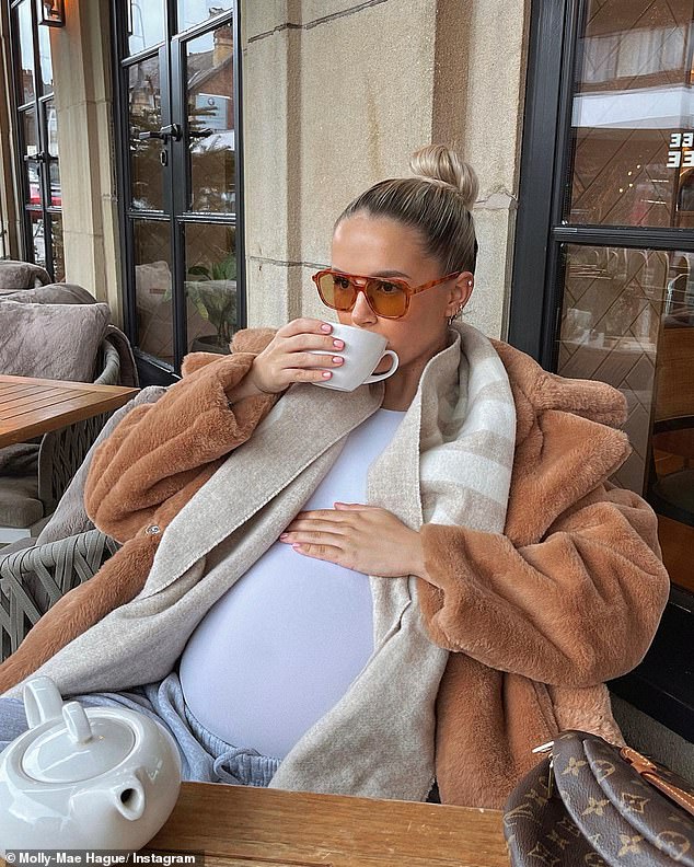 Baby love: The Love Island star, 23, looked effortlessly cool in her wrapped outfit as she placed her beer on top of her growing baby bump, which she says worked perfectly as a 'lovely teacup rack'