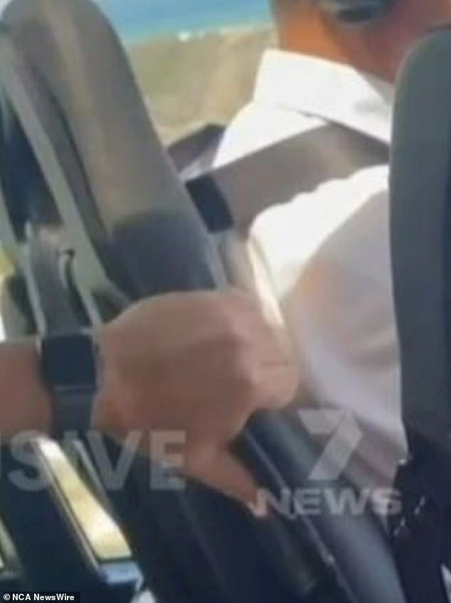 One of the passengers can be seen trying to alert the pilot.  7 News Credit: Channel 7