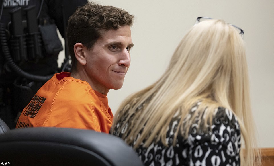 Idaho murder suspect Bryan Kohberger smiles at his attorney in court today as he is denied bail.  Kohberger will return to court on January 12