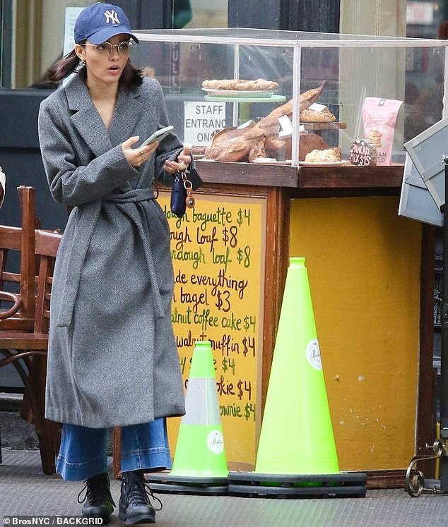 Motivator and shaker: The 21-year-old West Side Story star wrapped her petite frame in a stylish long gray coat and accessorized it with a Yankees cap.