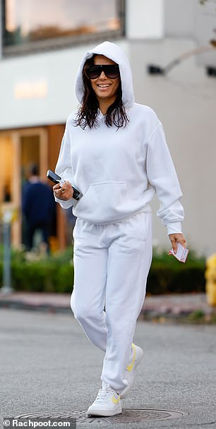 Bright White Smile: Longoria flashed a beaming smile as she took out her valet ticket and warmly handed it to the attendant.