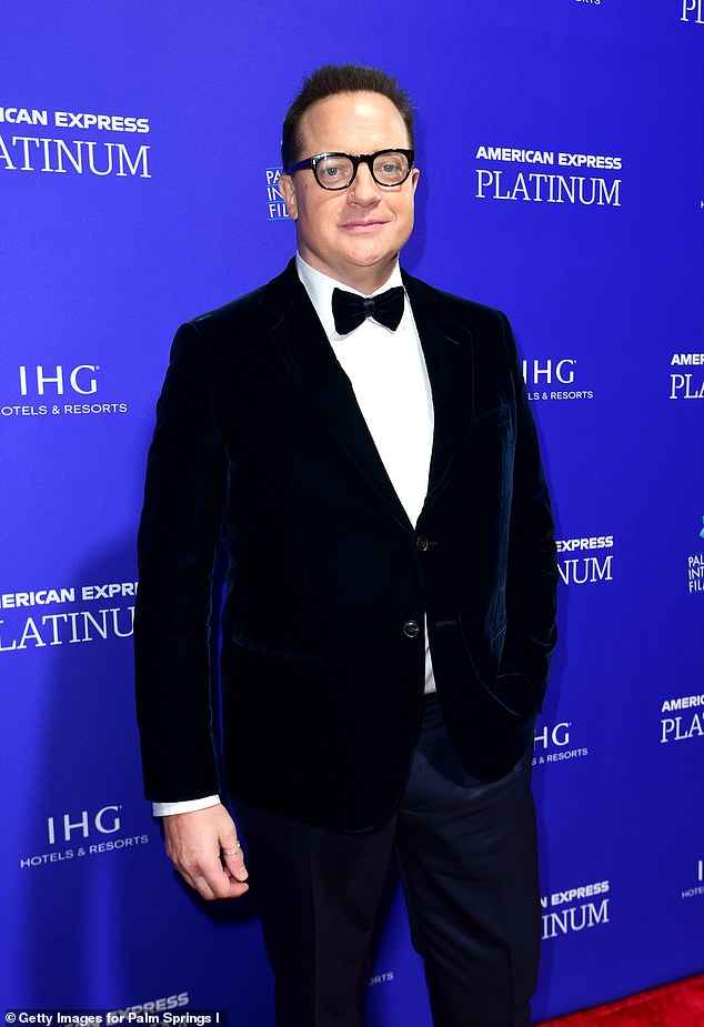 The actor walked the red carpet at the Palm Springs Convention Center in a dark blue coat over a white top with a bow tie with navy pants and black shoes.