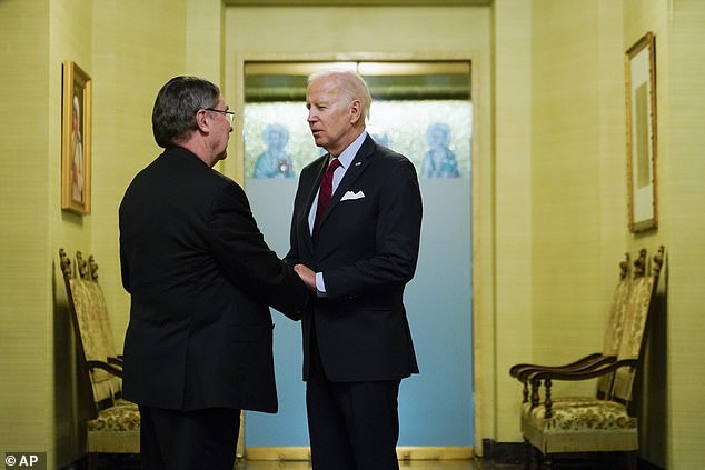 President Joe Biden (right) is greeted by Archbishop Christophe Pierre (left) as he arrives to express condolences for the late Pope Benedict at the Vatican diplomatic post in DC