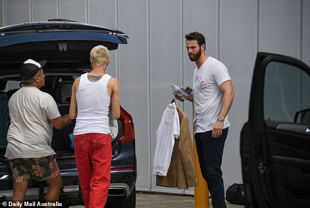 Felix and Jed were then seen loading the car full of costumes they wore during filming.