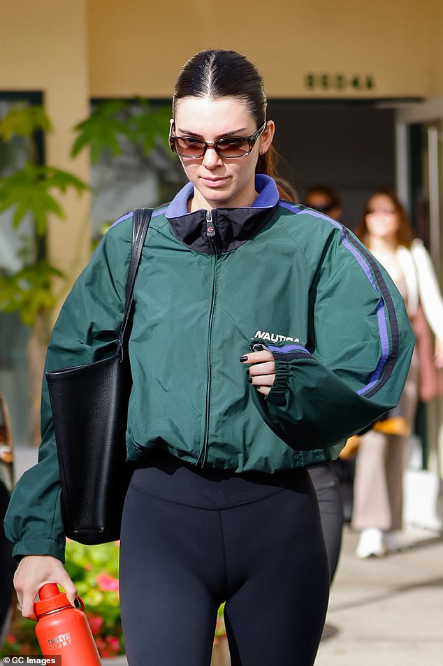 Beauty: She was makeup-free beneath her sleek shades and wore tiny silver-toned huggie earrings.