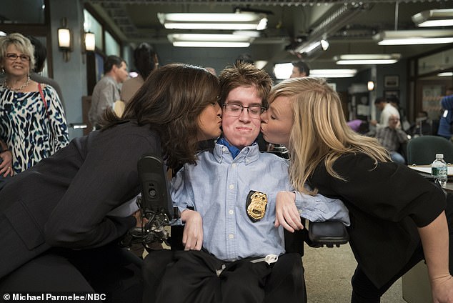 Law and Order actresses Mariska Hargitay and Kelli Giddish give Andrew a kiss as he visits the set of the show.