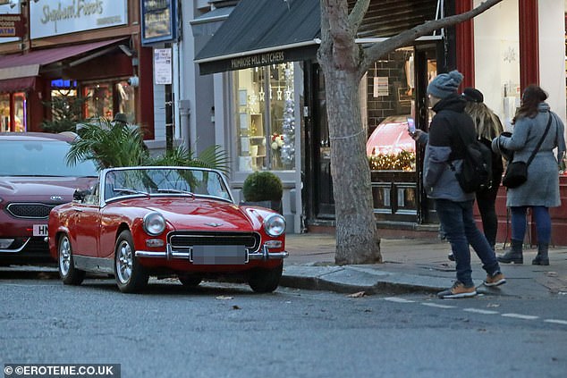 Eye-catching: The car caught the attention of passersby, including a man who took a picture of it with his phone on Thursday.