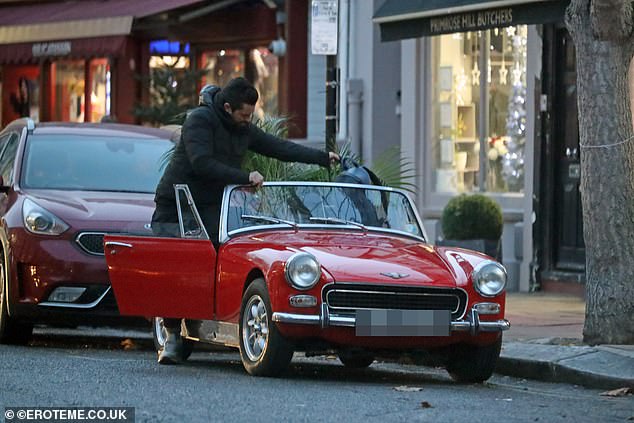 Small: Dominic was seen stuffing two huge plants and his backpack into the tiny sports car on Thursday, which retails for between £1,800 and £65,000 plus