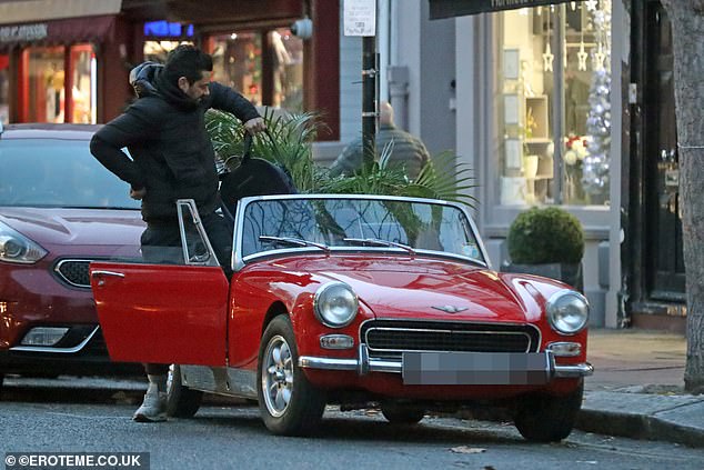 Day Trip: Mamma Mia!  The star donned a dark hoodie and pants with gray sneakers as she walked into the Austin Healey-Sprite on Thursday.