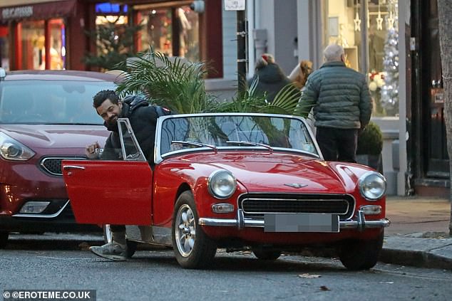 Tight squeeze: Dominic maneuvered his way into the small car, passing the massive two stories as he prepared to leave on Thursday