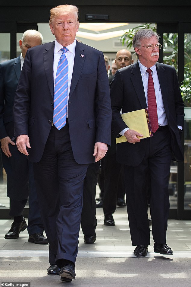 Trump walks with Bolton in 2019 after his early departure from the G7 summit in Canada