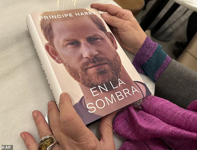 Harry has detailed startling revelations in his tell-all memoir, Spare, which leaked days before it was published (Pictured: A woman in Spain holding a copy of the book after it was accidentally released earlier in the country)