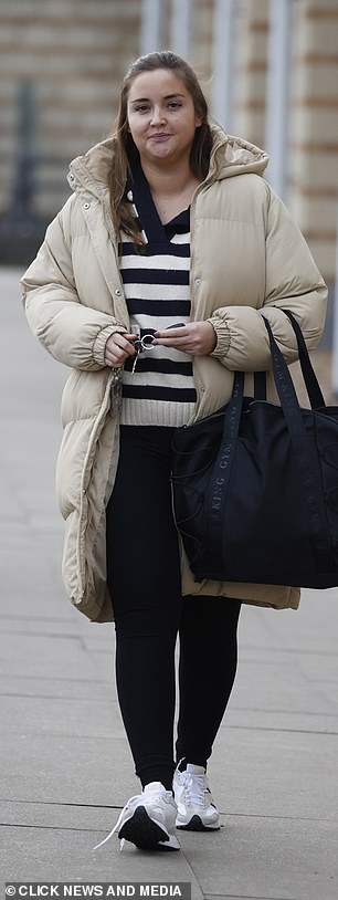 On the way home: Her oversized beige puffer jacket matched her comfy New Balance sneakers, which were perfect for her workout.