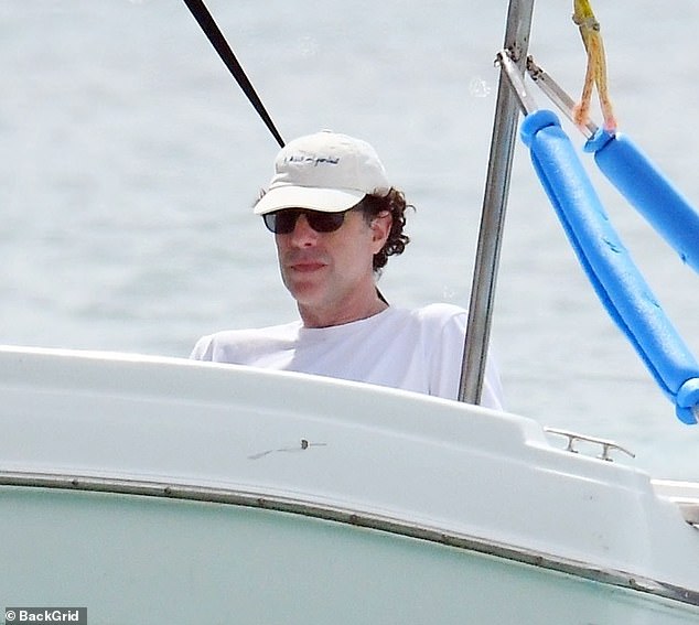 On the move: Isla was soaking up the sun from the shore while her husband Sacha Baron Cohen enjoyed a boat trip