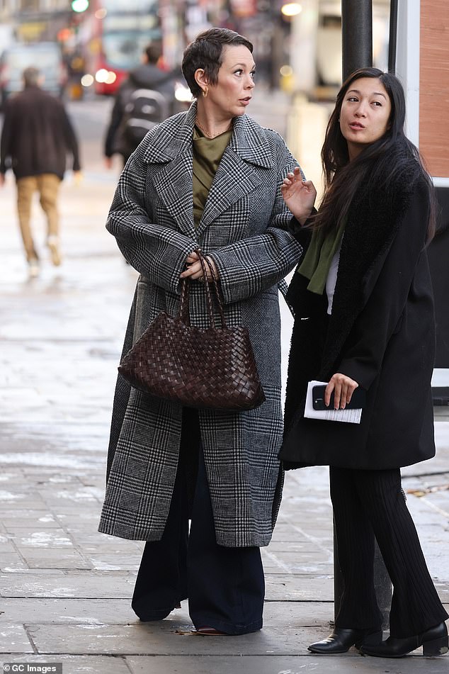 Out and about: She increased her height with a pair of leather boots and carried a burgundy woven bag to complete her look.