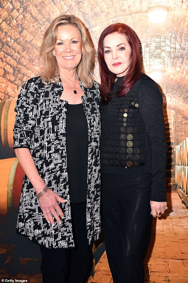 Elegant: The Dallas actress' bright red dyed hair fell to her shoulders and gave her look some extra color as she kept her makeup simple with a pink lip (pictured with Deb Linden)