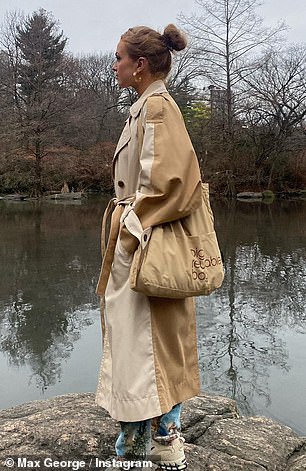 On-trend: Maisie went for a casual look in a beige and tan two-tone double-breasted mac over light wash jeans and chunky beige trainers, while accessorizing with statement gold jewellery.