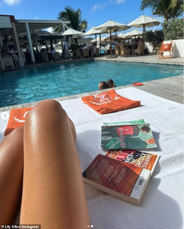 Complementing her tan: Lily had a blast during the sun-soaked break and shared this snapshot of David playing with his daughters while relaxing on a sun lounger