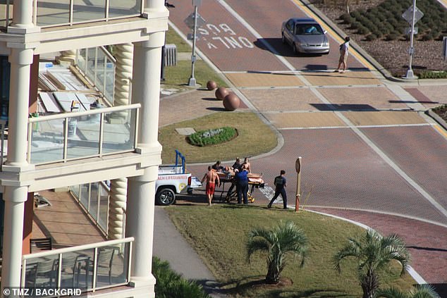 Hillis is seen being taken to an ambulance after a swimming accident on a Florida beach.