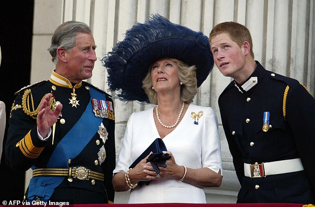 Prince Charles, Princess Camilla and Prince Harry watch poppies fall from a Lancaster bomb as she stands with Prince Andrew on the balcony of Buckingham Palace during celebrations marking the end of World War Two in London on July 10, 2005.