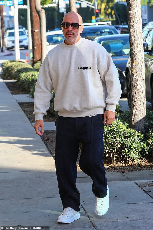 Sweater: Brett, 45, was wearing a white Essentials-brand sweater, which was written across the left side of his chest.