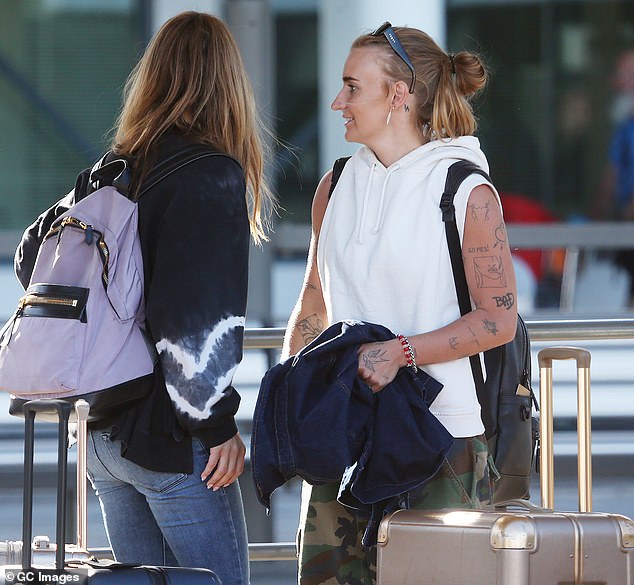 Without a hint of makeup in sight, G Flip pulled their golden locks up into a loose bun while wearing a dark blue jacket and accessorizing with various bracelets.