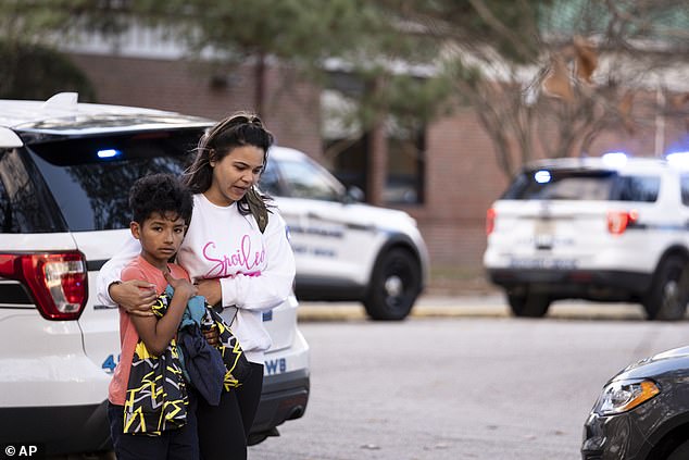 Carlos Glover, nine, (pictured) was seen leaving school with his mother Joselin after the shooting.  A student has been arrested, but the police have not released the student's name.