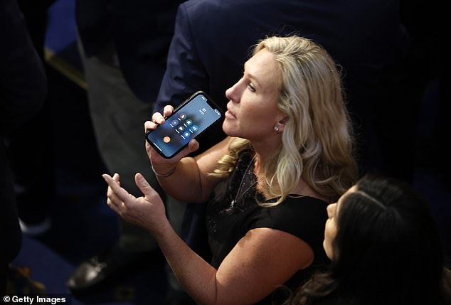 The initials of 'DT', former President Donald Trump, can be clearly seen on Greene's iPhone screen as it approached midnight on Friday and Republicans were about to make a 15th attempt to get Rep. Kevin McCarthy to cross the line.