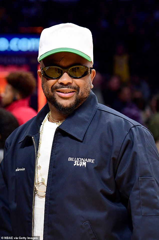 Cool cat: Singer-songwriter The Dream, 45, tried to go undercover wearing a white baseball cap with sunglasses from his courtside seat