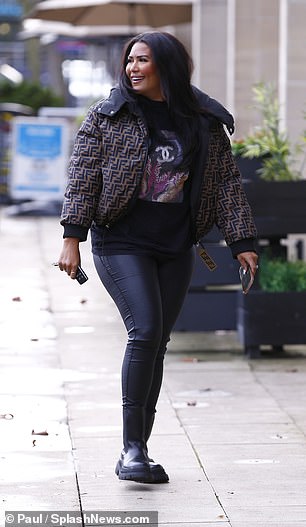 Heading to work: Rochelle looked in high spirits when she arrived at her living room.