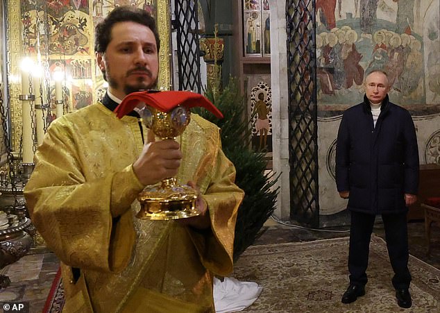 During the service, an armed presidential bodyguard appears fleetingly looking at the ruler, the Annunciation Cathedral in the Kremlin in Moscow, Russia, on January 6, 2023.