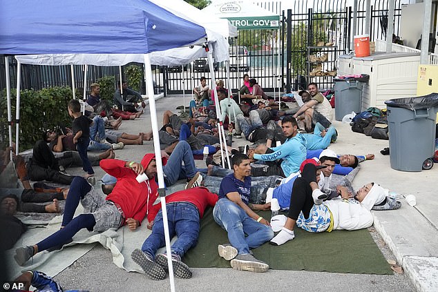 After arriving in the Florida Keys, migrants wait at the Marathon border station