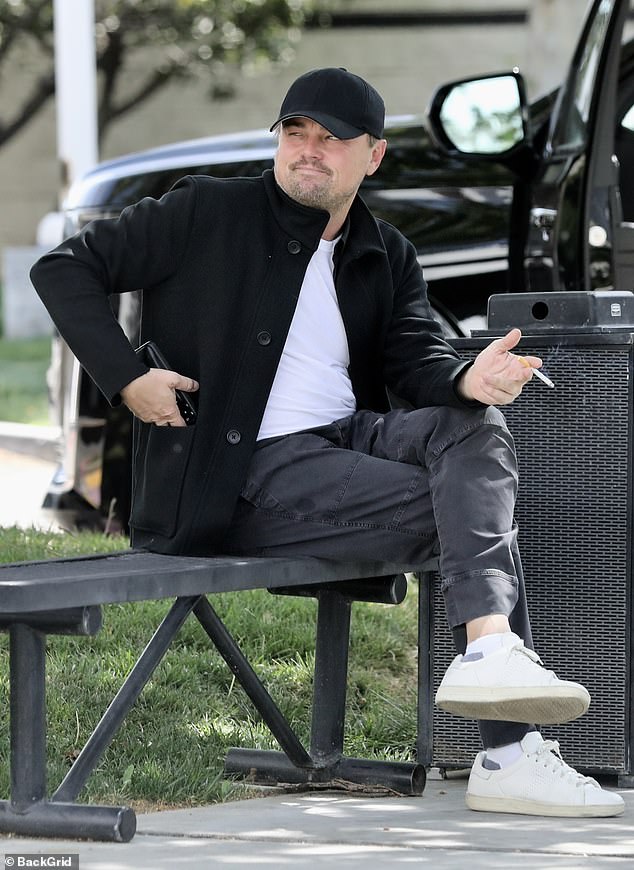 Leonardo looked unrecognizable while enjoying a cigarette at the private jet terminal in California in 2022.