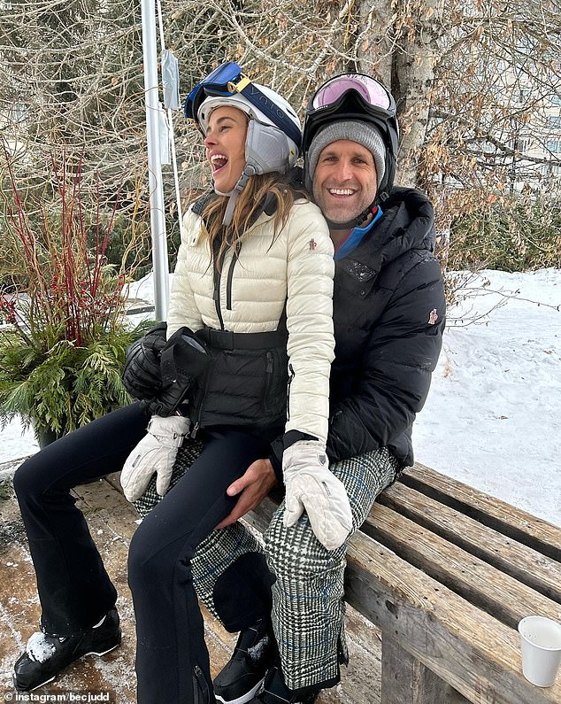 The WAG and her husband, AFL star Chris Judd, took their children, Oscar, 11, Billie, eight, and won Tom and Darcy, six, to escape the snow.  In the photo of her with her husband