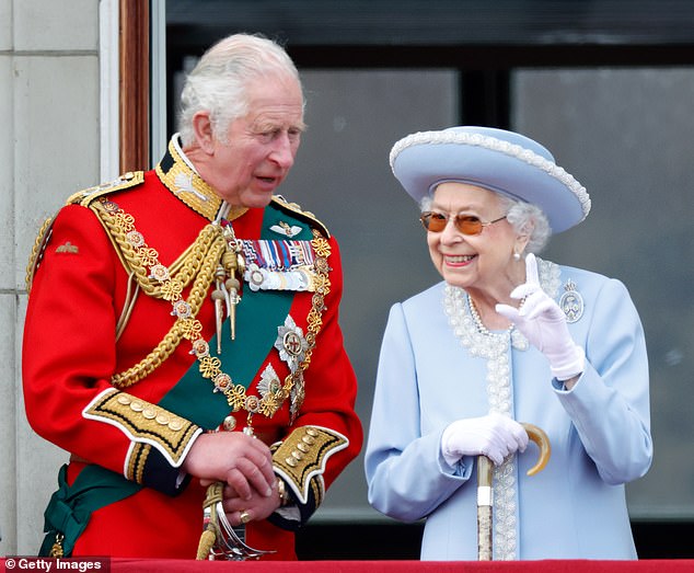 Prince Charles and Queen Elizabeth II watch an aerial flight from the balcony of Buckingham Palace during Trooping the Color on June 2 last year.